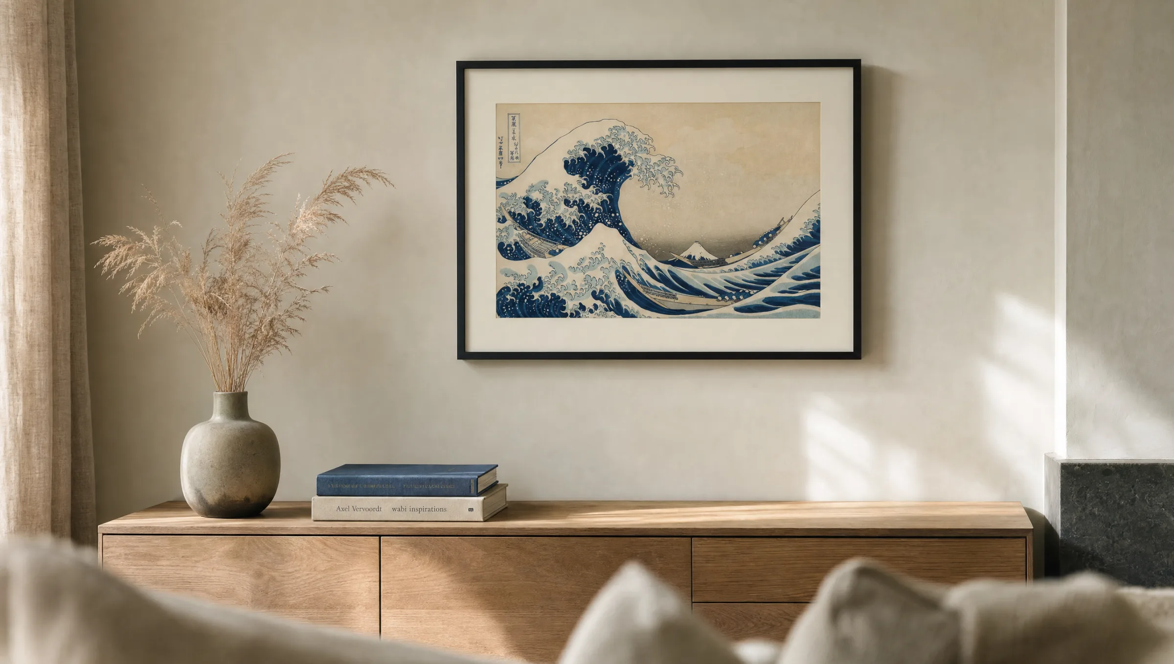 Living room wall with a framed print of Hokusai's Great Wave above a low oak sideboard