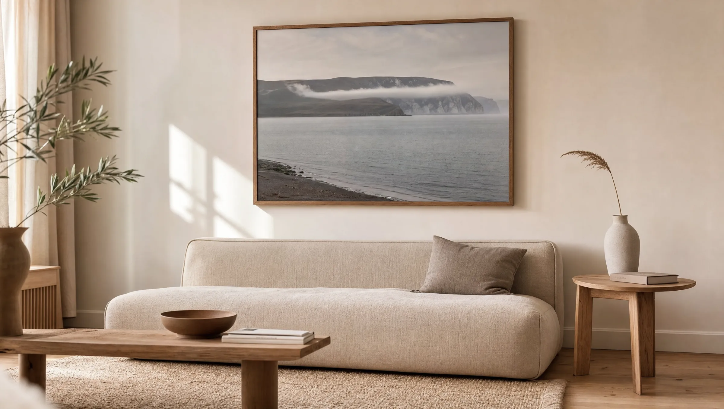 Living room with a large-format landscape poster above a linen sofa
