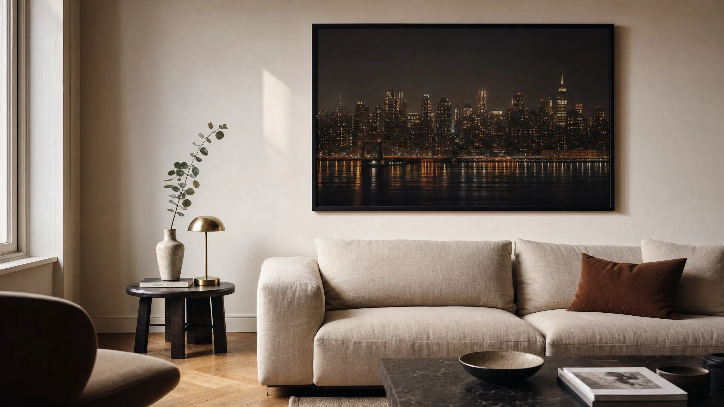 Living room with a framed metropolis poster of a nocturnal skyline hanging above a sofa